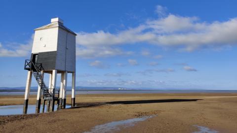 The beach at Burnham with blue skies behind
