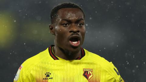 Marc Bola in a yellow Watford FC jersey during a match