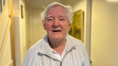 John Morley, who has short grey hair, wearing a grey quarter-zip fleece.