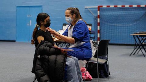 A student receives the Meningitis B vaccine at the University of Kent sports hall on March 19, 2026 in Canterbury, England.