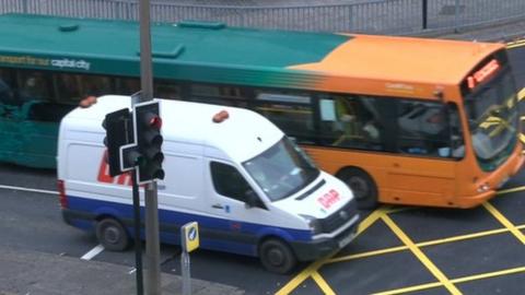 Cardiff bus and van at yellow box junction in the city centre