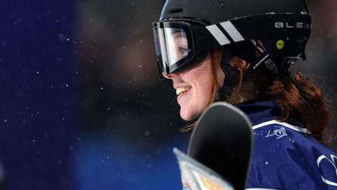 Close-up of Kirsty Muir. She has red hair and is wearing a black helment with goggles.