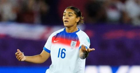 Footballer Jess Carter, wearing England's predominantly white shirt, is photographed during a game. She wears the number 16 shirt.