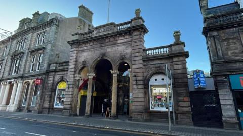 An entrance to the Victorian Market on Inverness' Academy Street. The buildings are of a Victorian design.