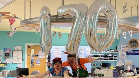 Two clowns on a ward in the Jenny Lind Children's Hospital with balloons that read 170
