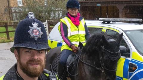 Police officer and woman on a horse
