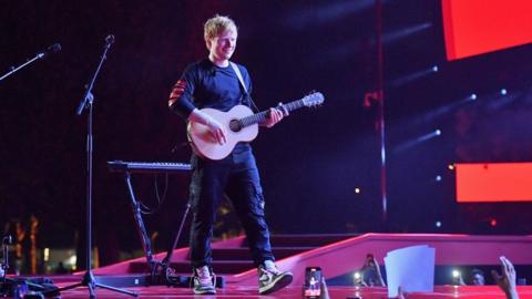 Ed Sheeran performing in front of Eiffel Tower