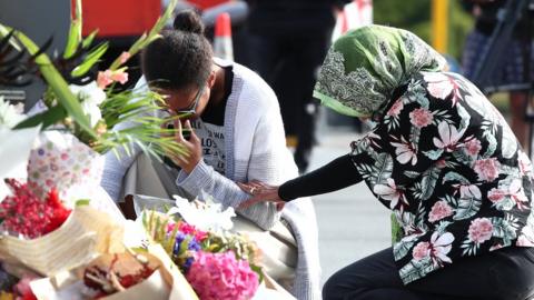 Locals lay flowers in tribute to those killed and injured at Deans Avenue near the Al Noor Mosque on March 16, 2019 in Christchurch, New Zealand
