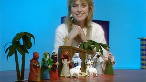 Janet Ellis sits behind her nativity scene 