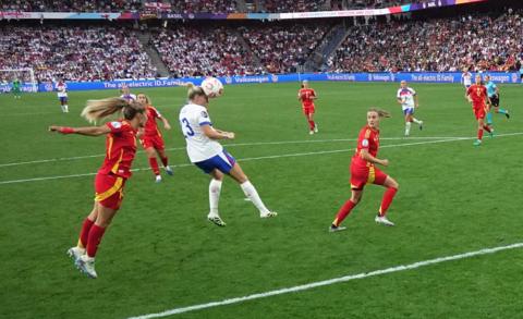 alessia russo heading the ball with an assist from chloe kelly as the spanish side look on