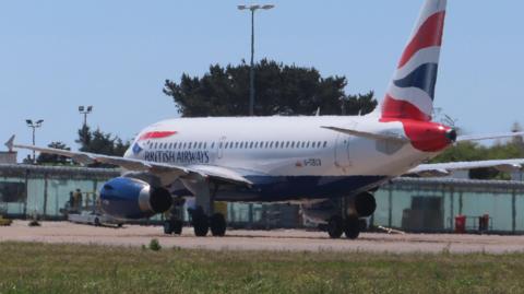 A British Airways plane lands on the runway at Guernsey Airport.