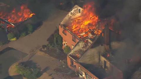 Aerial footage Flames and a plume of black smoke engulfing houses on residential street in Stourbridge  