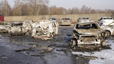 Burnt out cars following a reported drone strike in Russia