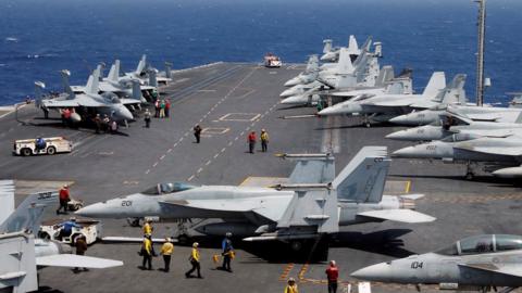 Aircraft on the USS Carl Vinson prepare to launch in the South China Sea.