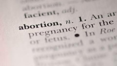 The word 'abortion' highlighted in a dictionary