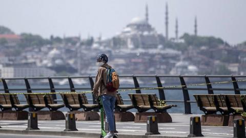 A woman riding a scooter in Istanbul