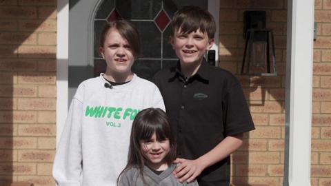 Children outside their front door.