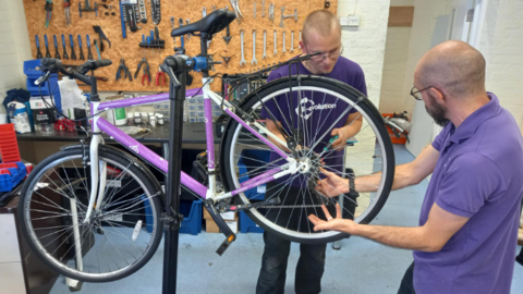 Mechanics work on a bike 