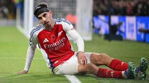 Kai Havertz sits on the floor after missing a chance