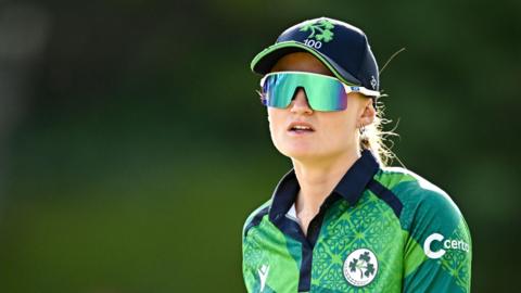 Gaby Lewis, wearing sunglasses and a cap, in the field for a recent Ireland match