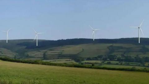A CGI of four wind turbines on a large hilly expanse of greenery.