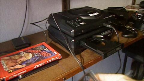 A Sega games console with a Night Trap case beside it.