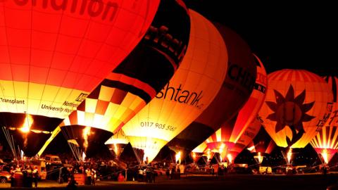 Balloons light up in the dark at the Bristol Balloon Fiesta