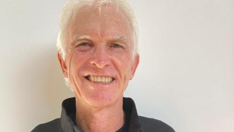 Craig Hogan looks on