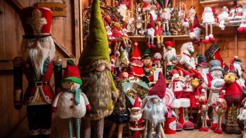 A selection of dozens of Christmas toys on display including santas, snowmen and elves 