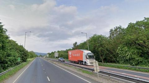 The A629 in North Yorkshire. Pictured is a two-lane carriageway with a clear road ahead, while a lorry and a car travel on the opposite carriageway