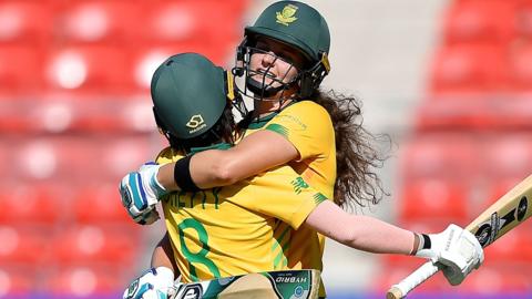 South Africa's Laura Wolvaardt celebrates her fifty by hugging Trisha Chetty