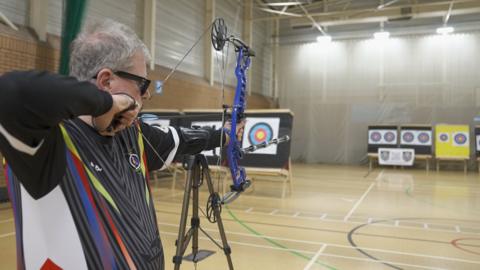 Roger shooting his arrow 