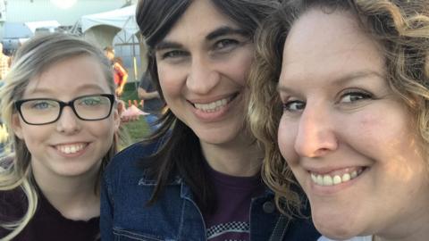 Three women smiling for a photo together