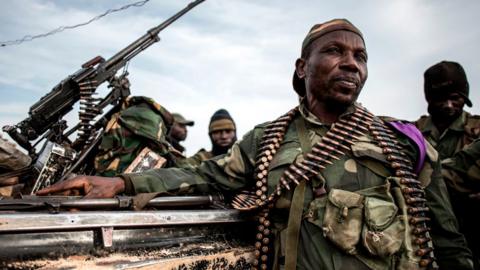 Soldiers of the Armed Forces of the Democratic Republic of the Congo (FARDC) sit in a truck bed in a base on July 3, 2019