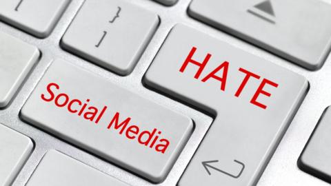 Image of a keyboard with words hate and social media superimposed