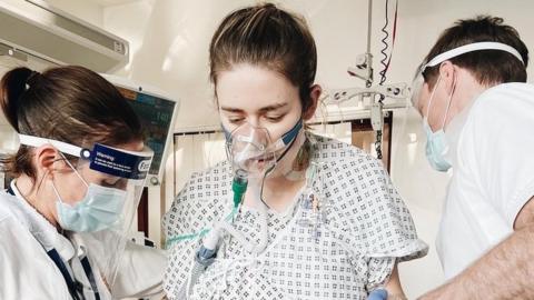 Catherine McCarroll is helped up by medics after her double lung transplant