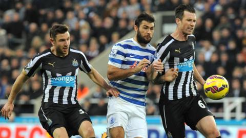 Paul Dummett and Mike Williamson playing together for Newcastle with QPR's Charlie Austin sandwiched in the middle 