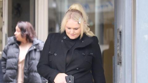 Hollie Dance leaving Southend Crown Court wearing a black coat