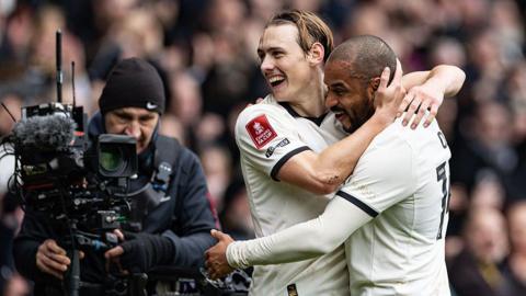 Port Vale players celebrate their goal against Sunderland in front of a TV camera operator
