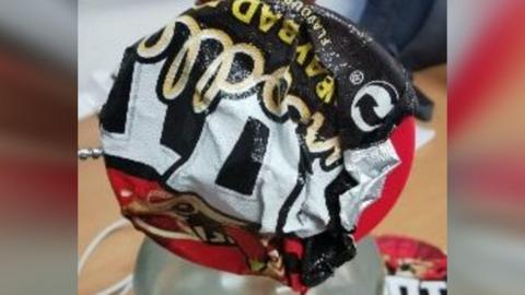 black and red pot noodle lid 