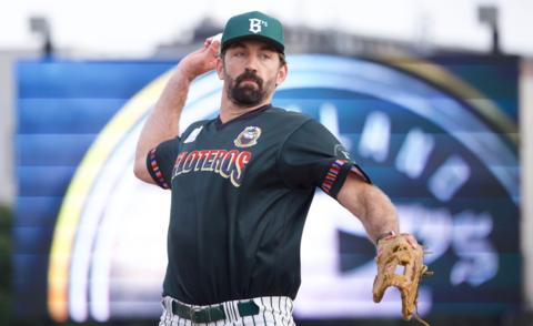 Former England cricketer Liam Plunkett throws a pitch for the Oakland Ballers baseball team