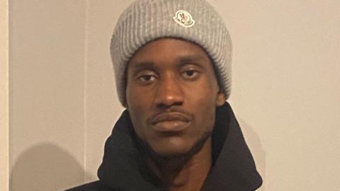 Messiah Robb in a grey knitted hat and a black hoodie.