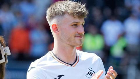 Ben Lloyd applauds after Swansea's game against Oxford in May