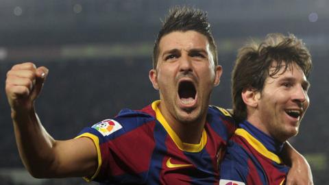 David Villa celebrates a goal with Lionel Messi