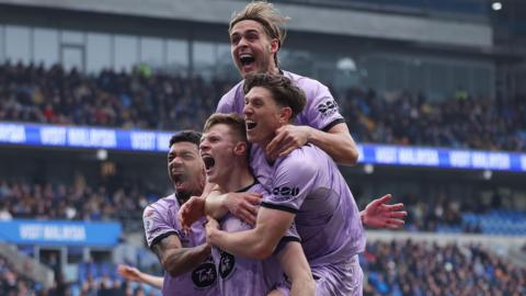 Lincoln celebrate their opening goal at Cardiff