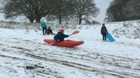 Man kayaks down hill