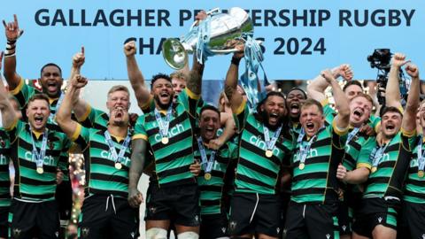 Northampton players lift the Premiership trophy