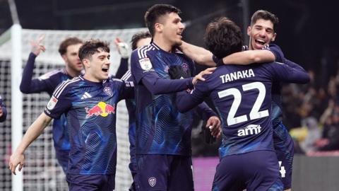 Leeds players celebrate with Ao Tanaka after Joel Piroe's goal at Watford