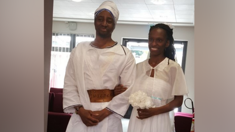 Tai and Naiyahmi Yasharahyalah on their wedding day wearing white clothes