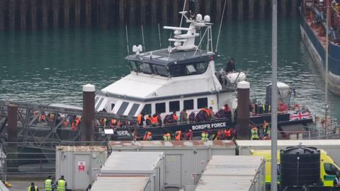 A group of migrants are brought in to Dover, Kent, from a Border Force vessel in the Channel.